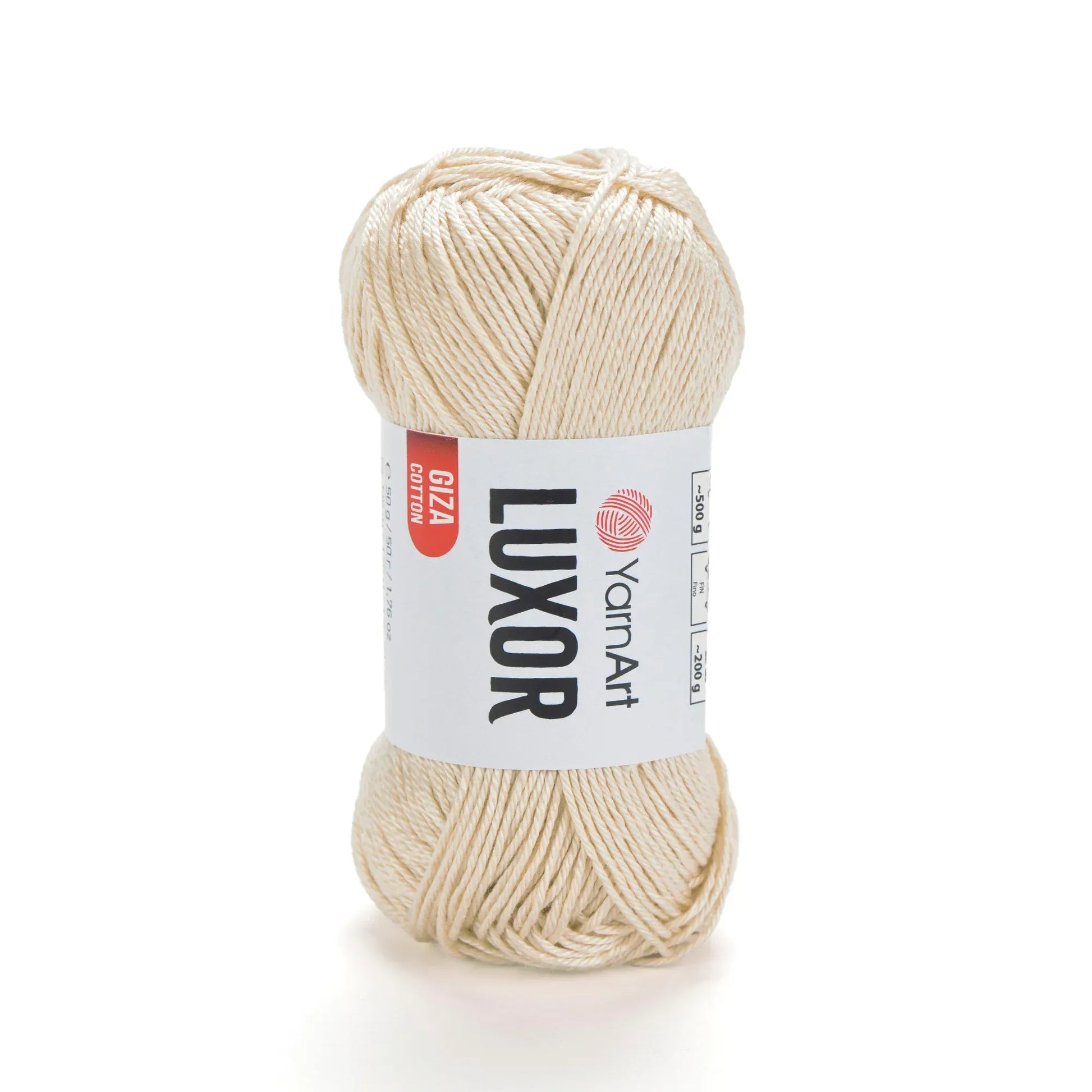 Ovillo de hilo YarnArt Luxor 100% algodón mercerizado Giza en un suave tono crema, con su etiqueta visible y fondo blanco.