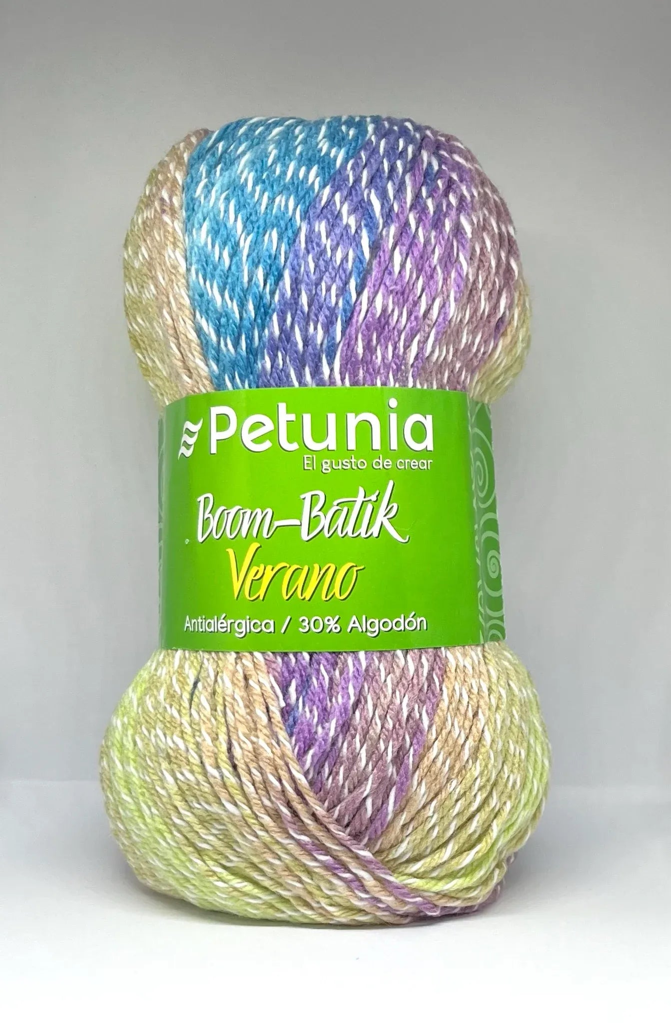Ovillo de lana Petunia Boom-Batik Verano, matizada en tonos azul, morado, beige y verde claro, ideal para tejer prendas antialergicas y frescas.