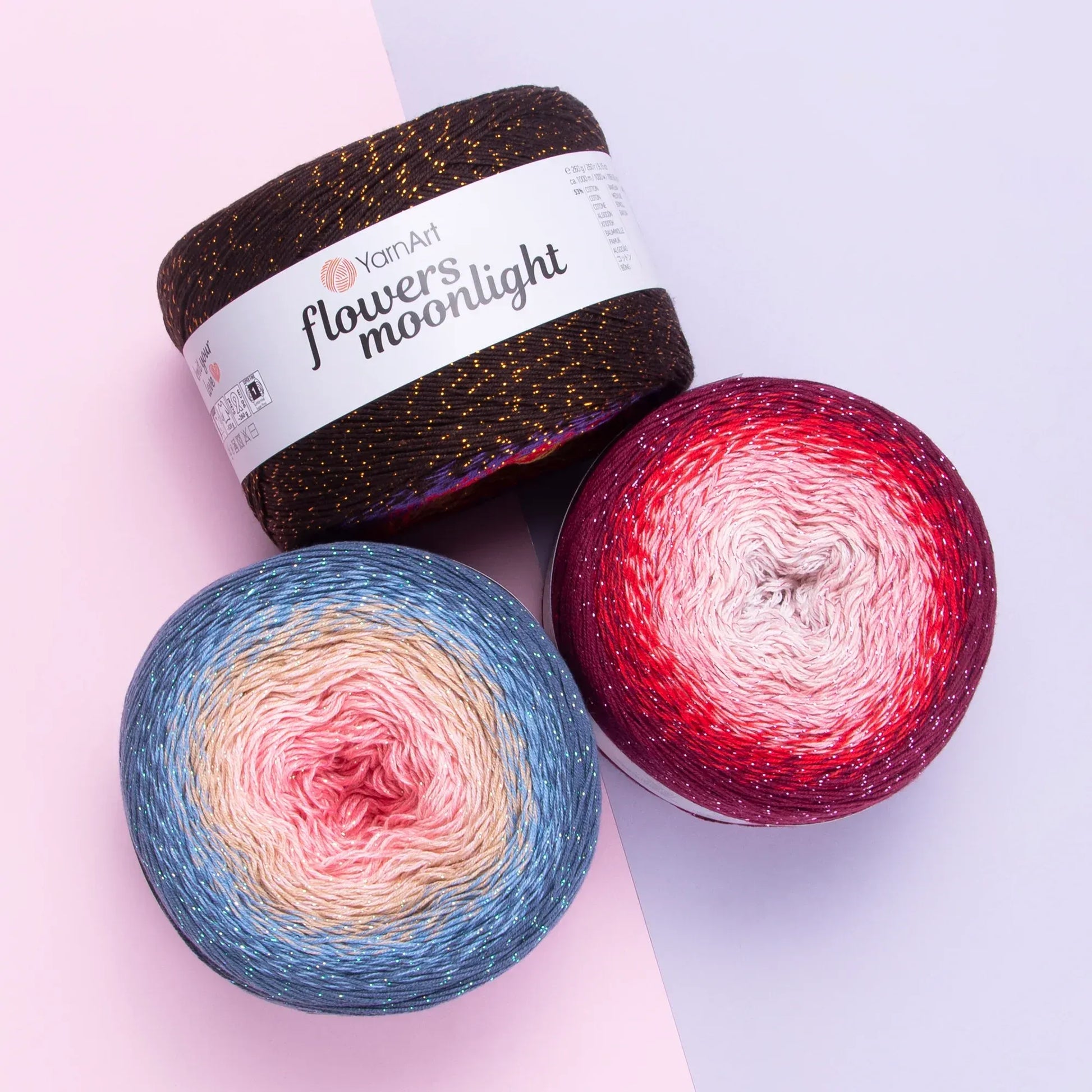 Tres ovillos de hilo YarnArt Flowers Moonlight degradé con brillo metálico en tonos cafe-dorado, azul-rosa y burdeo-rojo.